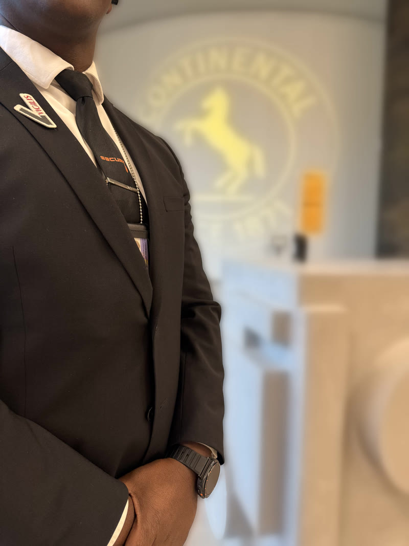 SECURY3 officer in a suit at the reception desk of an office building